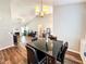 Inviting dining area with modern table set, chandelier, and view of living room at 5710 Stephens Mill Dr, Sugar Hill, GA 30518