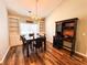 Cozy dining space with built-in shelving, modern light fixture, and dark wood furniture at 5710 Stephens Mill Dr, Sugar Hill, GA 30518