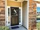 Inviting front entrance featuring a stylish door with sidelights and stone accents at 5710 Stephens Mill Dr, Sugar Hill, GA 30518