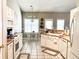 Charming kitchen featuring white cabinets, tile floors, and an adjacent breakfast nook at 5710 Stephens Mill Dr, Sugar Hill, GA 30518