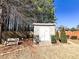 Backyard shed with double doors and bench seating nearby at 5710 Stephens Mill Dr, Sugar Hill, GA 30518