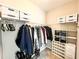 Walk-in closet with custom shelving and storage for clothes and shoes at 5710 Stephens Mill Dr, Sugar Hill, GA 30518