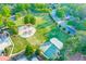 Aerial view of a playground, basketball court and green space in the community at 708 Players Ct, Woodstock, GA 30189