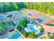 Aerial view showcasing community amenities including pool, tennis courts, and lush landscaping at 708 Players Ct, Woodstock, GA 30189