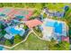 Aerial view of community amenities featuring pools, tennis courts, and parking at 708 Players Ct, Woodstock, GA 30189