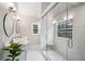 Bright bathroom featuring tiled walk-in shower with glass door, dual sinks, and modern fixtures at 708 Players Ct, Woodstock, GA 30189