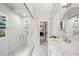 Sleek bathroom featuring large walk-in shower with pebble floor, modern fixtures, and a window at 708 Players Ct, Woodstock, GA 30189