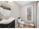 Cozy bathroom featuring a vanity with sink, toilet, and shower-tub combo with a neutral color scheme at 708 Players Ct, Woodstock, GA 30189