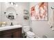 Stylish half-bathroom featuring shiplap walls, modern fixtures, and a unique cow wall art at 708 Players Ct, Woodstock, GA 30189