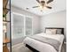 Well-lit secondary bedroom with a ceiling fan, and a large window at 708 Players Ct, Woodstock, GA 30189