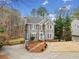 Charming two-story home with gray siding, a manicured front yard and inviting front door at 708 Players Ct, Woodstock, GA 30189