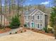 Charming home with gray siding, manicured front yard, and inviting front door at 708 Players Ct, Woodstock, GA 30189