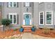 Inviting front entrance with a blue door, decorative wreath, and charming landscaping at 708 Players Ct, Woodstock, GA 30189