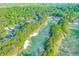 Overhead shot of pristine golf course and mature trees amidst upscale residential area at 708 Players Ct, Woodstock, GA 30189