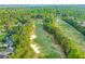 Aerial view of lush golf course with manicured greens in an upscale neighborhood at 708 Players Ct, Woodstock, GA 30189