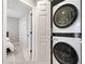 Efficient laundry room with modern stackable washer and dryer, optimizing space and convenience at 708 Players Ct, Woodstock, GA 30189