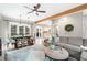 Spacious living room adjacent to the dining area with modern furniture and a decorative ceiling fan at 708 Players Ct, Woodstock, GA 30189