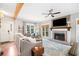 Open-concept living room with a cozy fireplace, a wooden ceiling beam, and a comfortable sofa at 708 Players Ct, Woodstock, GA 30189