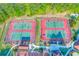 Aerial view of community tennis courts with players, surrounded by lush landscaping and trees at 708 Players Ct, Woodstock, GA 30189