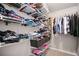 Organized walk-in closet with shelving and hanging rods, providing ample storage space for clothes at 708 Players Ct, Woodstock, GA 30189