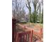 View from the deck showcasing a spacious backyard with mature trees and a wooden fence at 805 Wayside Dr, Lawrenceville, GA 30046