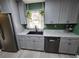 Modern kitchen featuring gray cabinets, stainless steel appliances, and a black sink at 805 Wayside Dr, Lawrenceville, GA 30046