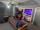 Entertainment room with arcade games, large TV, and ceiling fan at 805 Wayside Dr, Lawrenceville, GA 30046