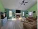 Bright living room with vaulted ceiling, stone fireplace, ceiling fan, and gray wood flooring at 805 Wayside Dr, Lawrenceville, GA 30046