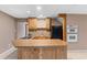 Basement kitchen features a breakfast bar, stainless steel appliances, and wooden cabinets at 3222 Bay View Dr, Jonesboro, GA 30236