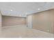 Tiled basement room featuring neutral paint, recessed lighting, and a white door at 3222 Bay View Dr, Jonesboro, GA 30236