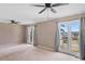 Carpeted bedroom boasts two ceiling fans and two windows with views of the neighborhood at 3222 Bay View Dr, Jonesboro, GA 30236