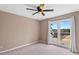 Cozy bedroom with natural light, featuring a ceiling fan, neutral walls and view from the windows of a scenic neighborhood at 3222 Bay View Dr, Jonesboro, GA 30236