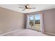 Cozy bedroom features plush carpet, neutral walls, and a sunlit window with soft pink curtains at 3222 Bay View Dr, Jonesboro, GA 30236