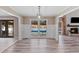 Dining room featuring white walls, modern lighting, and view of backyard swimming pool at 3222 Bay View Dr, Jonesboro, GA 30236