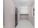 Entry hallway featuring tile floors, overhead cabinets, and white trim at 3222 Bay View Dr, Jonesboro, GA 30236