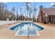 Large in-ground pool with stamped concrete patio and privacy fence at 3222 Bay View Dr, Jonesboro, GA 30236