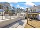 Back patio with wrought iron railing, stone columns, outdoor lights, and access to the home at 5245 Emmett Still Rd, Loganville, GA 30052