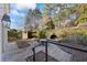 Stone patio with wrought iron railing overlooks a sunken sitting area and lush landscaping at 5245 Emmett Still Rd, Loganville, GA 30052