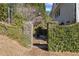 Private backyard patio featuring stone pillars and lush greenery, ideal for outdoor relaxation at 5245 Emmett Still Rd, Loganville, GA 30052