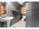 Stylish bathroom with a pedestal sink, shelving, and sleek black walls at 5245 Emmett Still Rd, Loganville, GA 30052