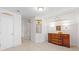 A large bedroom features a decorative wall mirror, moulding and a vintage dresser at 5245 Emmett Still Rd, Loganville, GA 30052