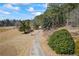 Long, scenic driveway leading to a beautiful estate surrounded by mature trees and open land at 5245 Emmett Still Rd, Loganville, GA 30052