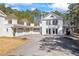 Stunning exterior view of a grand white home with multiple garage spaces and ample parking at 5245 Emmett Still Rd, Loganville, GA 30052