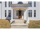 Elegant front entrance with stately columns and a beautifully crafted wooden door at 5245 Emmett Still Rd, Loganville, GA 30052