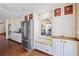 Charming kitchen with stainless steel refrigerator, built-in window seat, and stylish cabinetry at 5245 Emmett Still Rd, Loganville, GA 30052