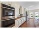 Kitchen with modern oven, sink, stainless steel refrigerator, and ample natural light at 5245 Emmett Still Rd, Loganville, GA 30052