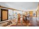 Open living room with hardwood floors, iron railing, chandelier, columns, built-in shelving, and large windows offering natural light at 5245 Emmett Still Rd, Loganville, GA 30052