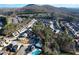 An aerial view showcasing the neighborhood, mature trees, and community layout nestled near a mountain at 167 Marlow Dr, Woodstock, GA 30188