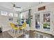Cozy dining area with a bench seat, bright yellow chairs, and access to the outdoor patio through french doors at 167 Marlow Dr, Woodstock, GA 30188