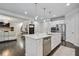 Bright kitchen with stainless steel appliances, pendant lighting, and a large island with white marble countertops at 167 Marlow Dr, Woodstock, GA 30188